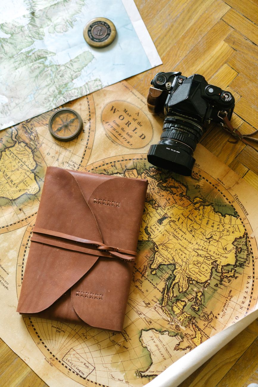 Travel writer examining maps in a light-filled studio