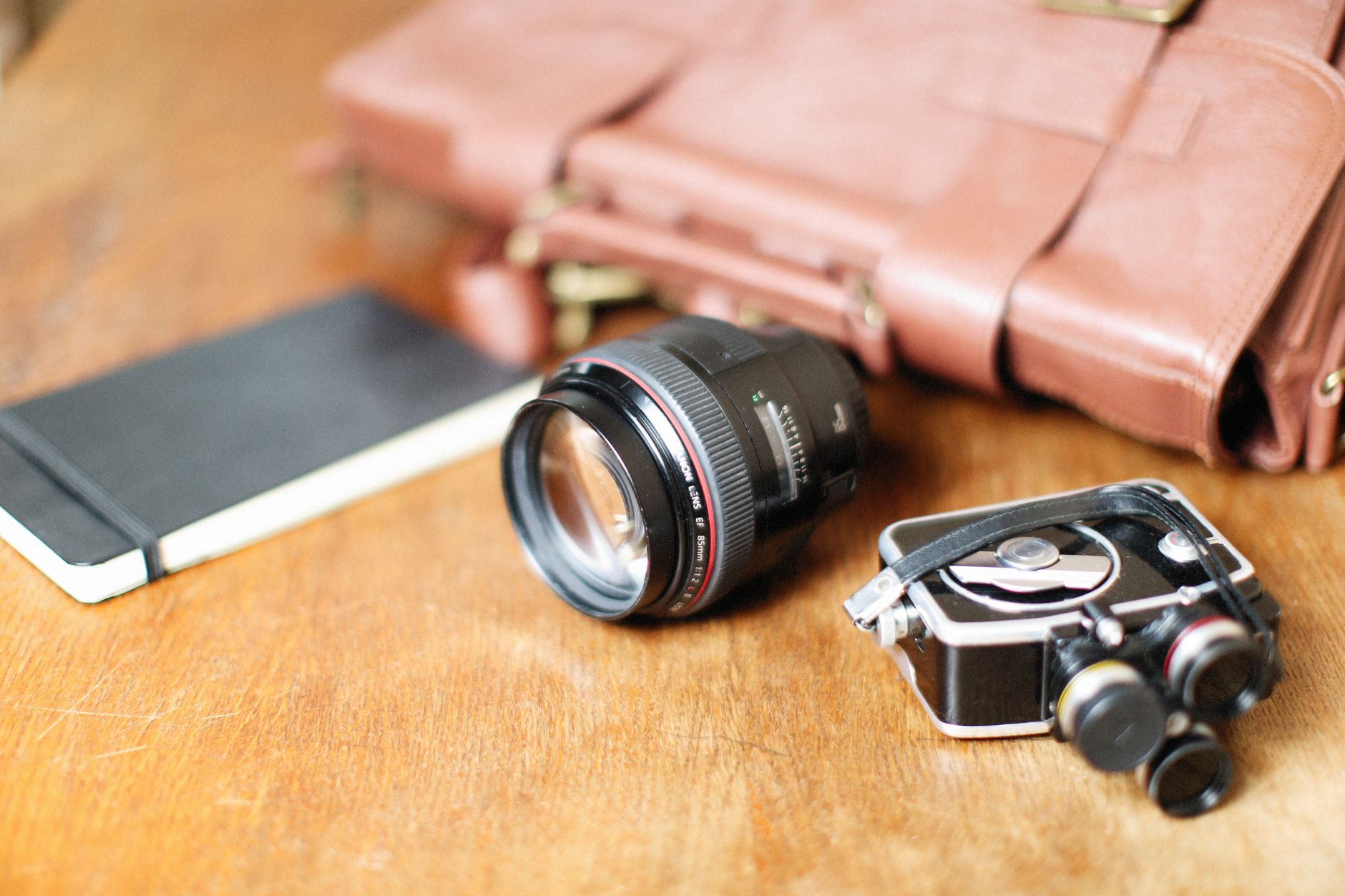 Bespoke travel notebook and camera on timber table